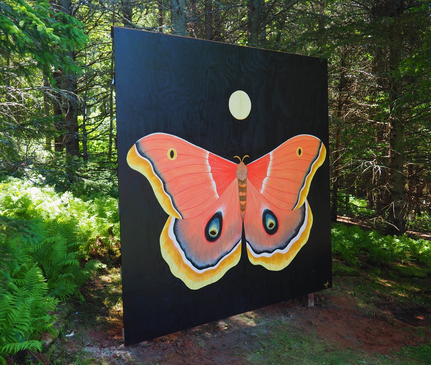 Large scale mural of moth in woods at Gardens of Hope, PEI