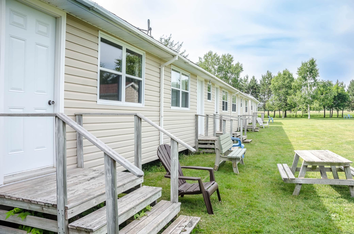 Strip motel with several units together with steps to each unit.