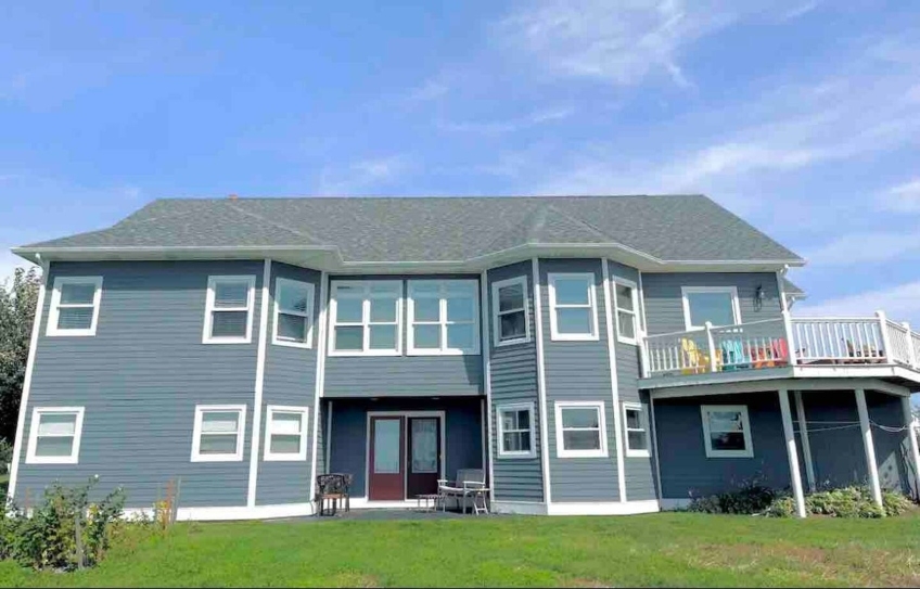Large two-storey blue home overlooking North Rustico Harbour