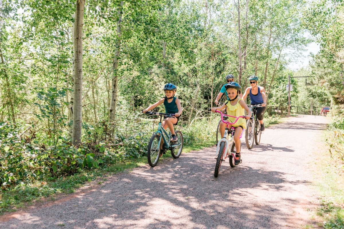 Rotary Friendship Park, Summerside, PEI Family of four cycle along trails in Summerside