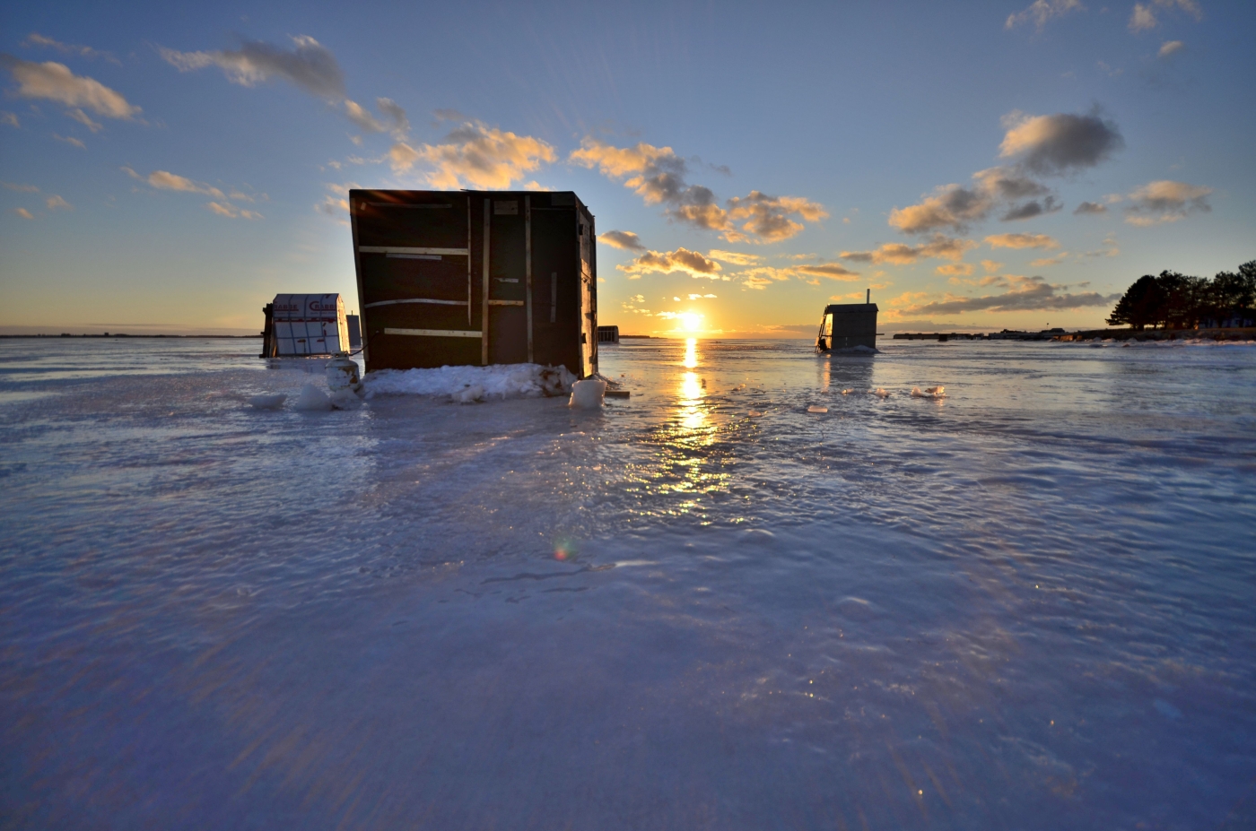 View of smelt shack on harbour at sunset