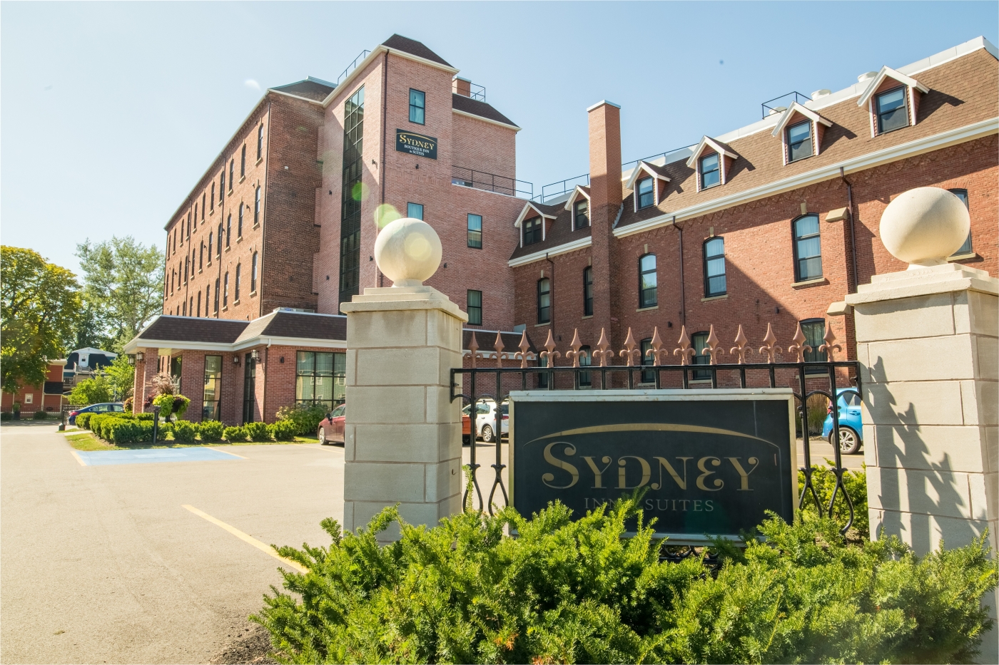 Historic brick building in down Charlottetown with gate entrance and shrubs
