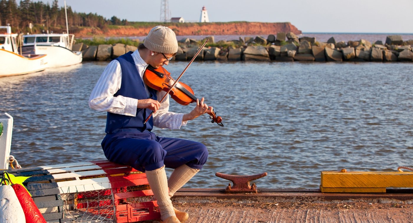 Fiddle, ocean, lobster traps, musician