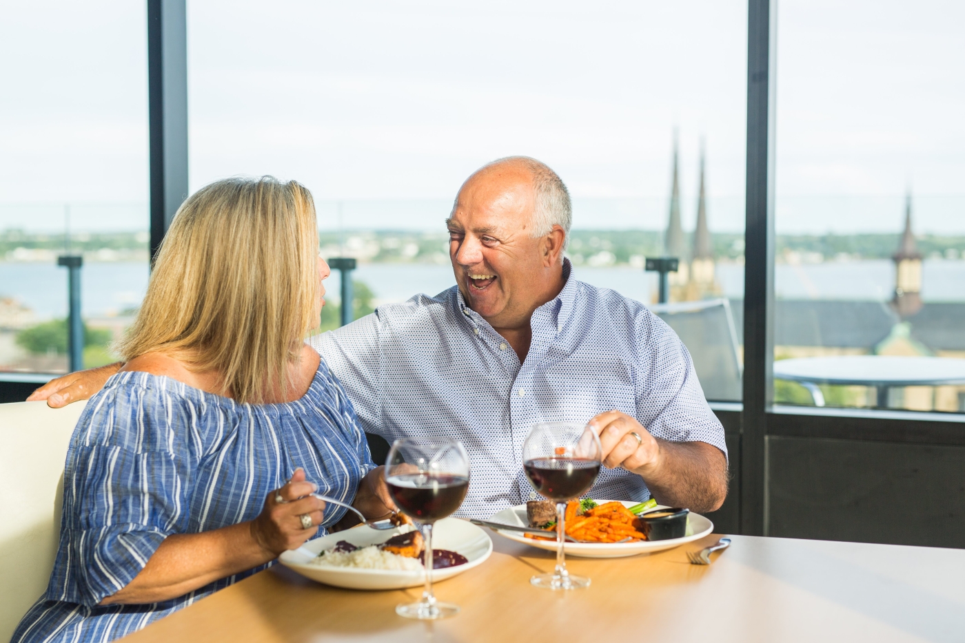 Male and female couple enjoying a meal and glass of wine