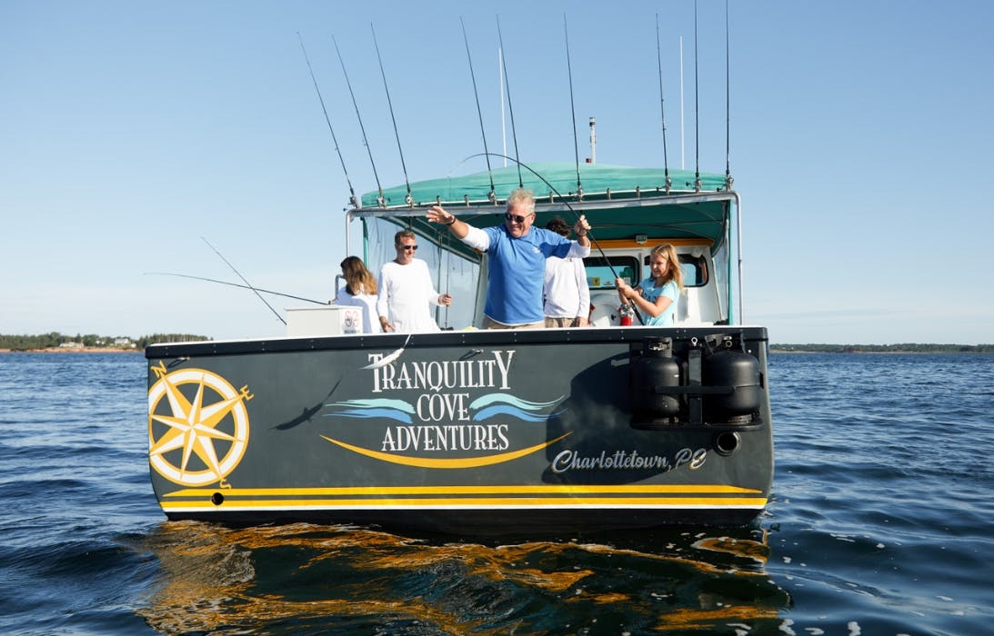 Family onboard fishing vessel fishing mackerel