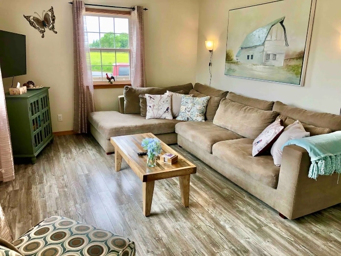 Vista Dos Holding photo of living room with beige sectional coffee table, chair and Tv