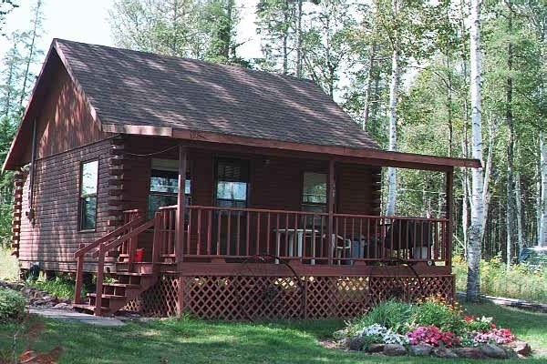 outside view of a log cabin with front porch