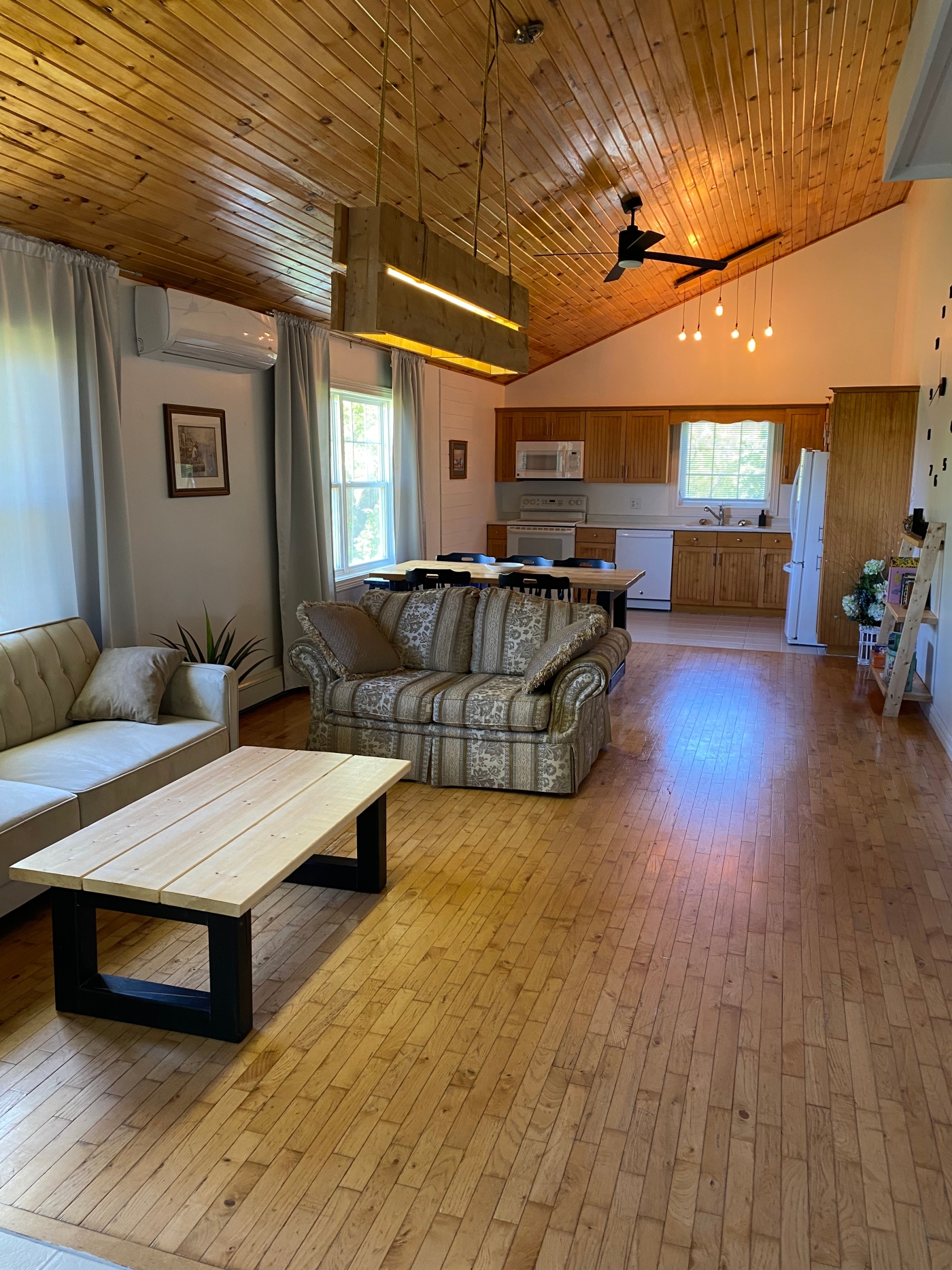 Loft Apartment photo of living room and kitchen area with couch and chair with coffee table