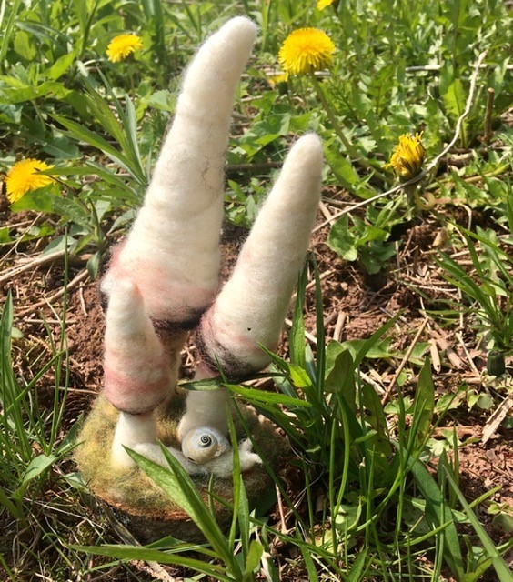Messy Crow picture of felt art created sitting in the grass