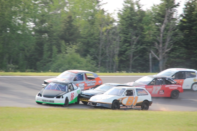 Six cars racing at the Oyster Bed Speedway
