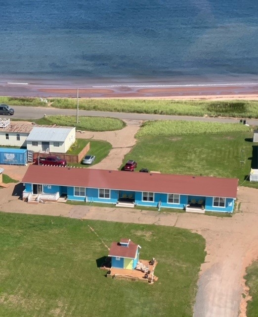 Airele photo of motel with sandy beach in background