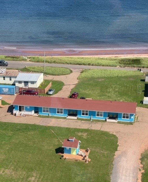 Sirerns beach Motel Airele photo of motel with sandy beach in background