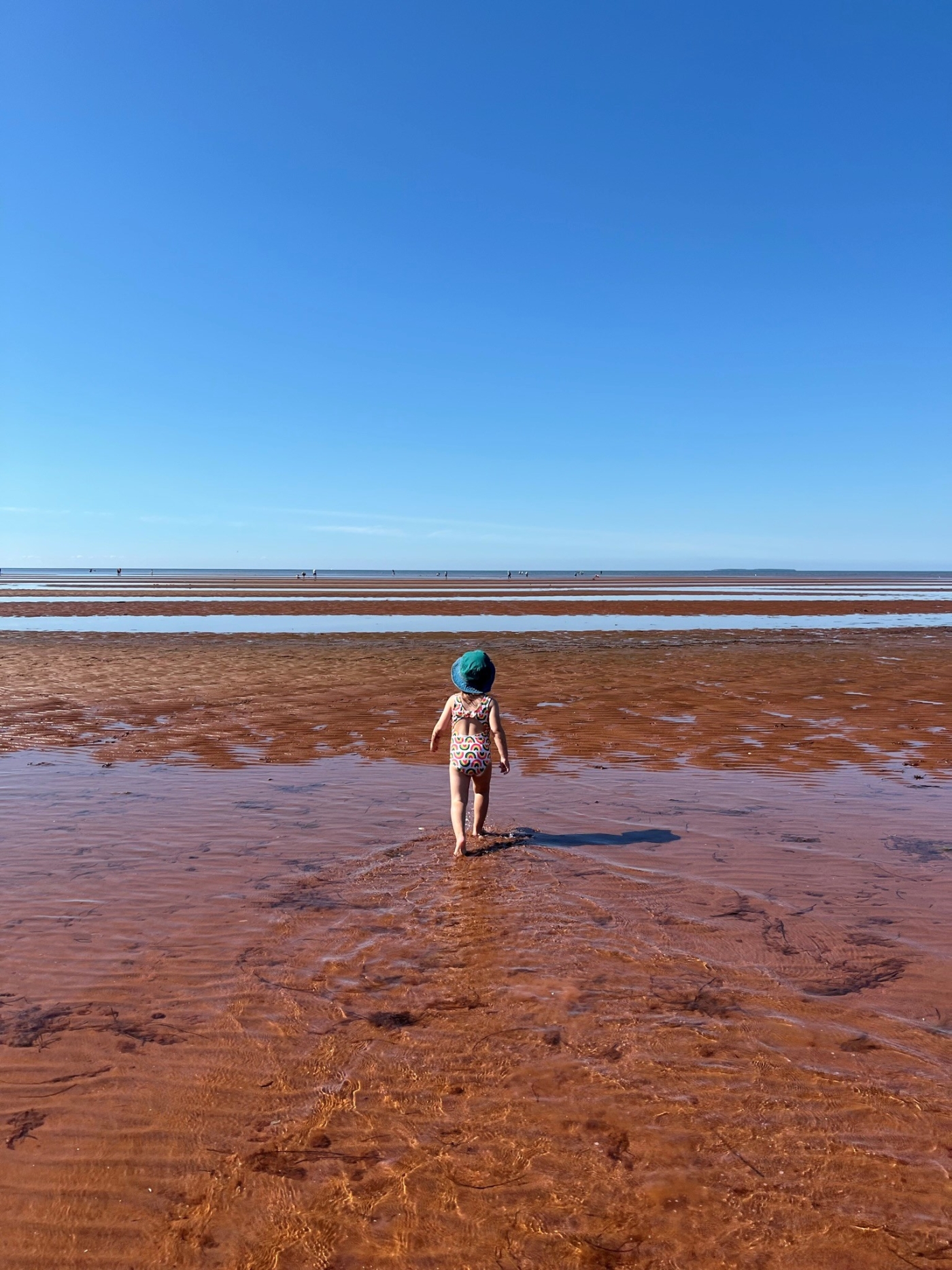 Tea Hill Park, Stratford, PEI Child walking across sand bar at low tide at Tea Hill Park