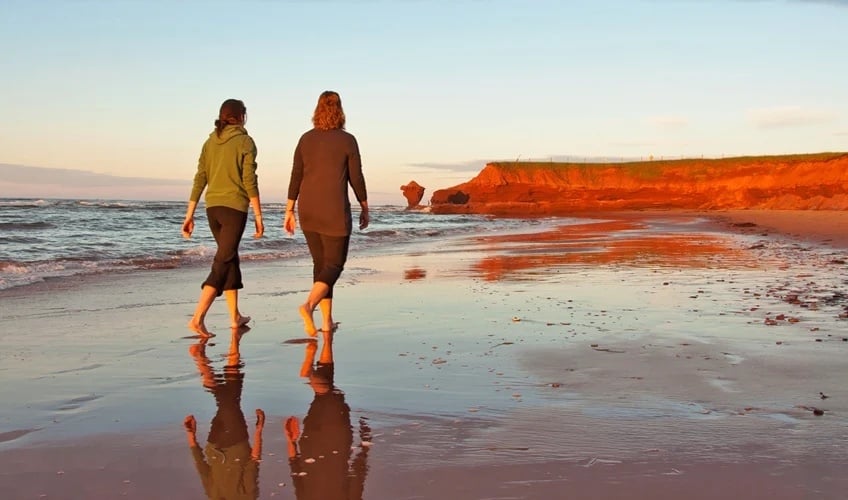 two women walking on the beach