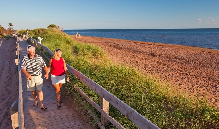 couple walking on a beach boardwalk