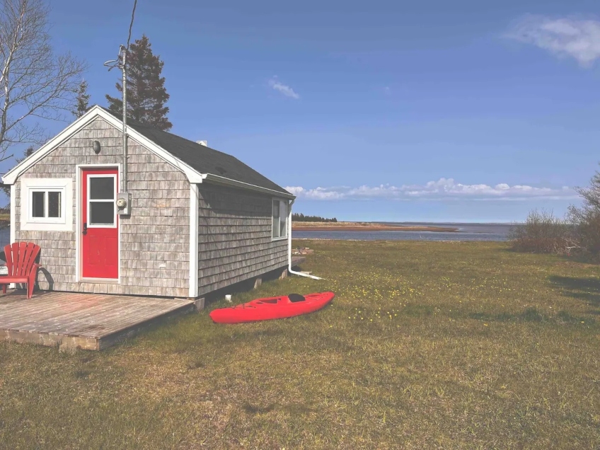 Wildflower Shackteau small shingled cottage with deck and red door