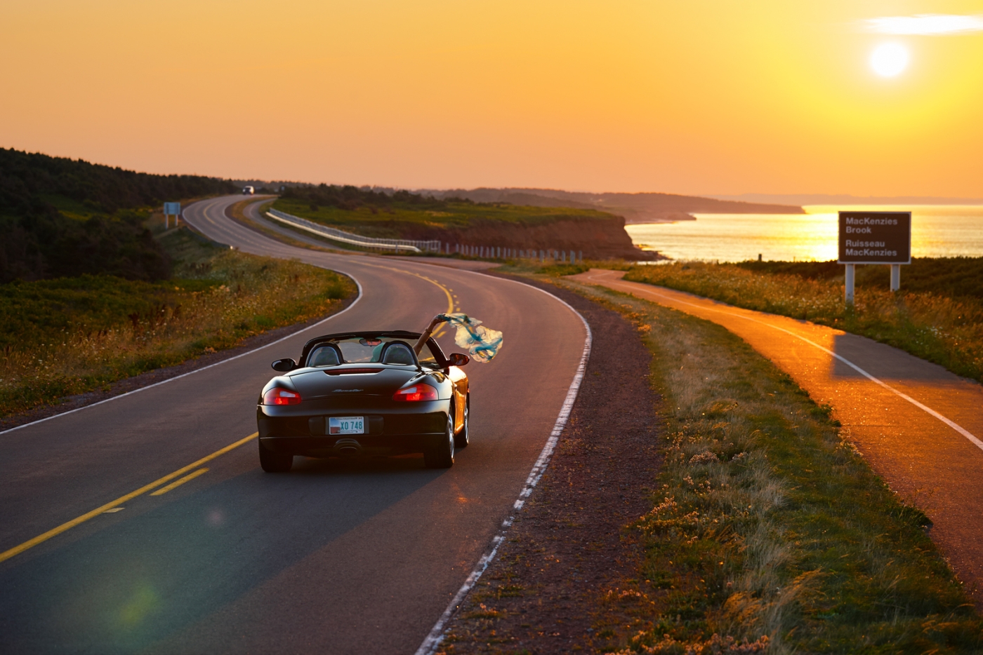 Convertible drives along the coast in PEI National Park, MacKenzie Brook